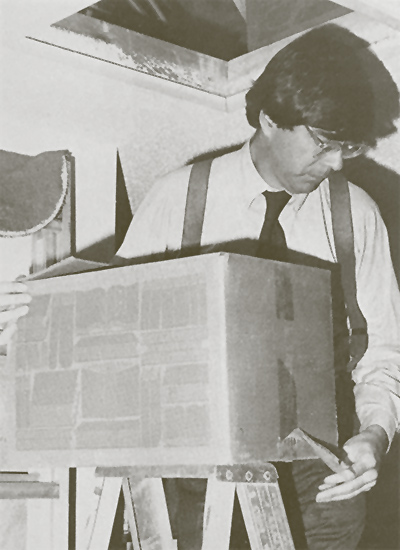 Western Electric attorney Patrick Leach removing box of documents from Mim's attic. (Forrest Mims)